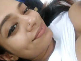 A beautiful Sri Lankan woman records a video of herself taking selfies