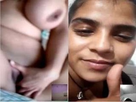 A stunning girl flaunts her breasts and pleasures herself with her hands