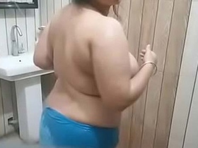 Explore the hidden desires of a bhabha with big boobs in a risquÃ© bathroom video