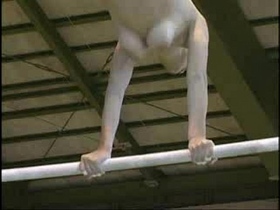 Watch as a gymnast performs her moves with ease and grace