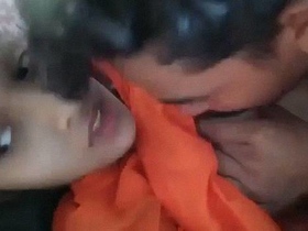 Watch a couple of Indian teenagers indulge in boob sucking on the couch