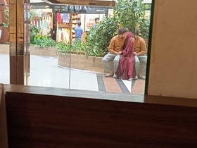 Smooching in a public space with a hint of naughtiness