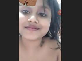 Young girl flaunts her breasts in a seductive manner