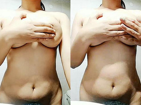 Indian college girl squeezing and playing with her boobs in the bathroom