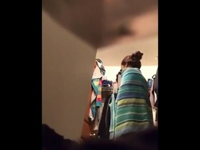 A cute Indian girl undressing and dressing in the bathroom