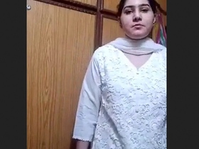 Watch a stunning brunette strip down to her lingerie in a striped suit