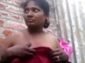 Watch a local girl in a bathroom stripping down to her halter top