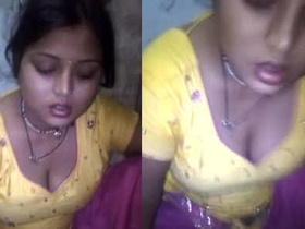 A young girl enjoys a meal while showcasing her ample cleavage