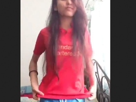 A stunning young woman strips naked and displays her gorgeous figure